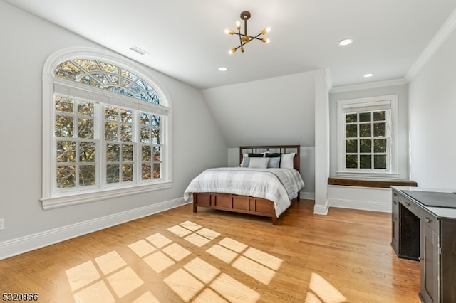 bedroom featuring crown molding, lofted ceiling, light hardwood / wood-style flooring, and a chandelier