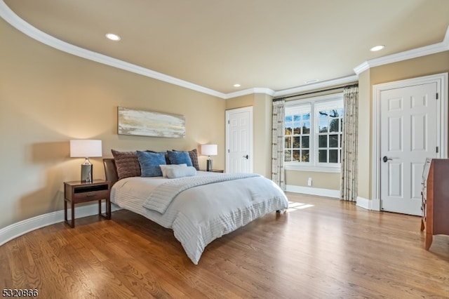 bedroom with light hardwood / wood-style floors and crown molding