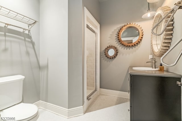 bathroom featuring a shower with door, vanity, toilet, and tile patterned flooring