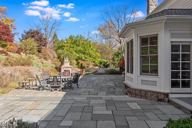 view of patio featuring an outdoor stone fireplace