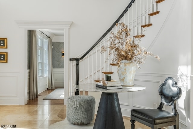 dining space featuring ornamental molding and light tile patterned floors