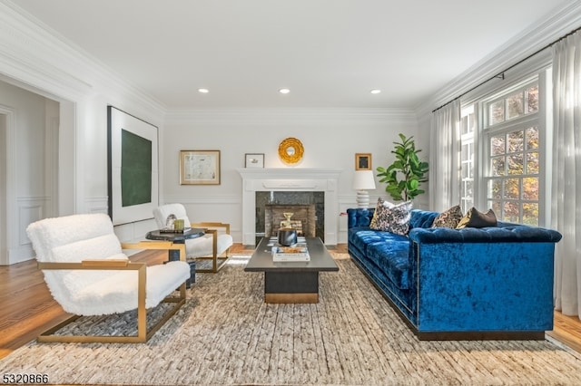 living room with hardwood / wood-style flooring and ornamental molding