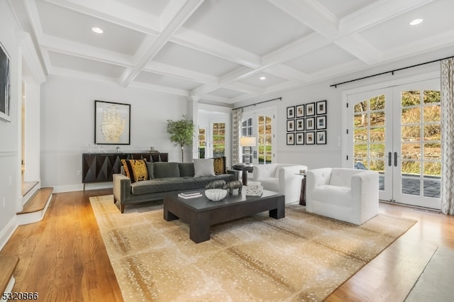 living room with beamed ceiling, french doors, coffered ceiling, and a healthy amount of sunlight