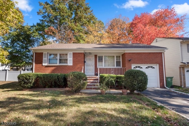 view of front of house featuring a garage and a front lawn