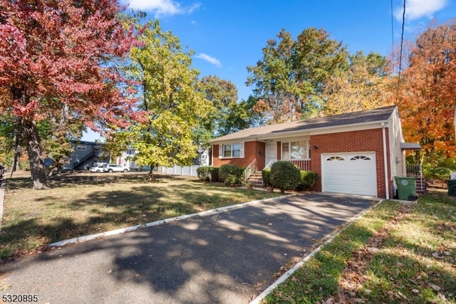 view of front of house featuring a garage and a front lawn