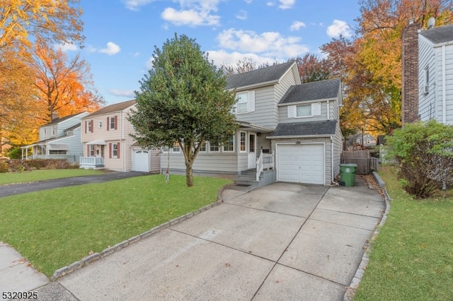 view of front of house with a front lawn and a garage