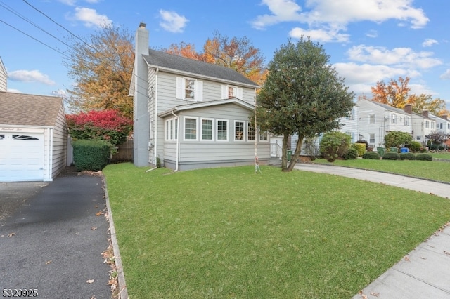 view of front of home featuring a garage and a front lawn