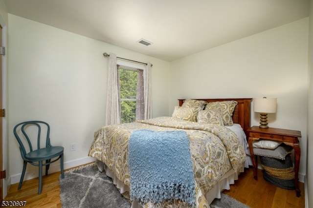 bedroom with hardwood / wood-style floors