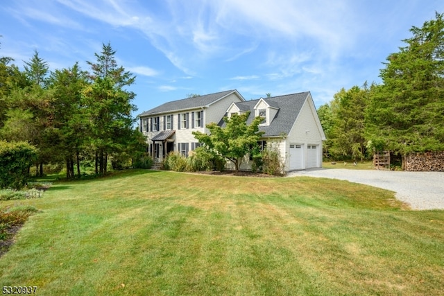 view of front of property featuring a garage and a front lawn