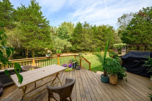 wooden deck featuring a lawn