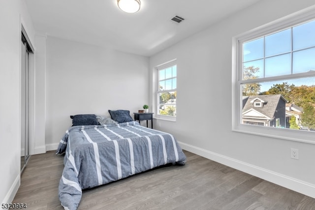 bedroom with hardwood / wood-style flooring