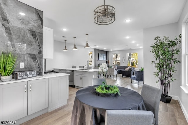 dining room featuring light hardwood / wood-style flooring and sink