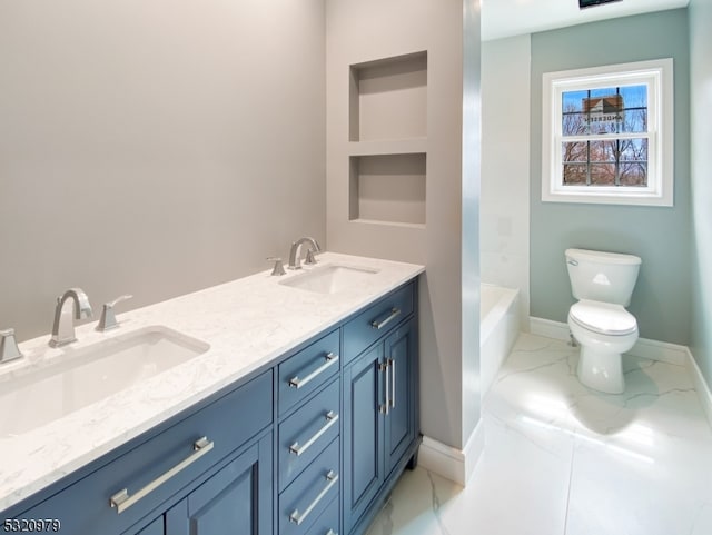 bathroom with vanity, toilet, and a washtub