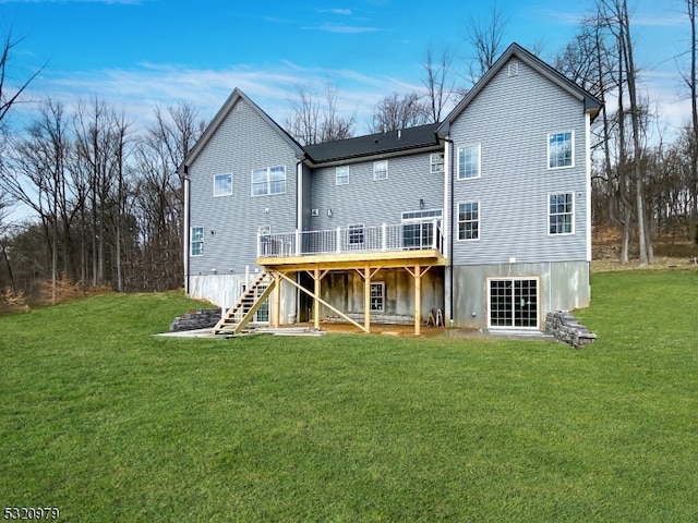 rear view of property with a wooden deck and a yard