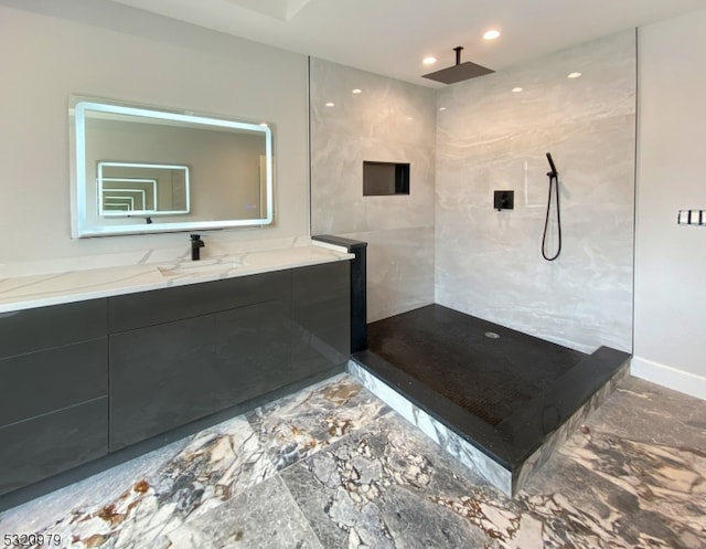 bathroom featuring vanity and a tile shower