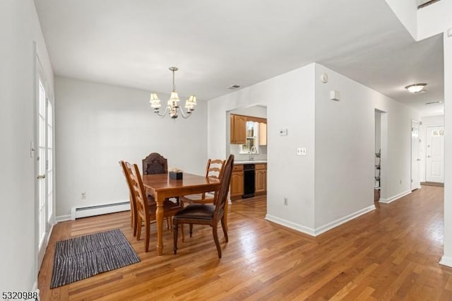 dining space featuring wood-type flooring, sink, a notable chandelier, and baseboard heating