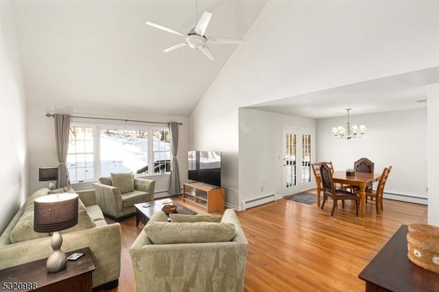 living room with a baseboard heating unit, ceiling fan with notable chandelier, high vaulted ceiling, and hardwood / wood-style floors