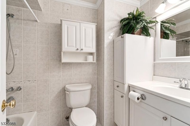 full bathroom featuring toilet, crown molding, tile walls, vanity, and tiled shower / bath combo