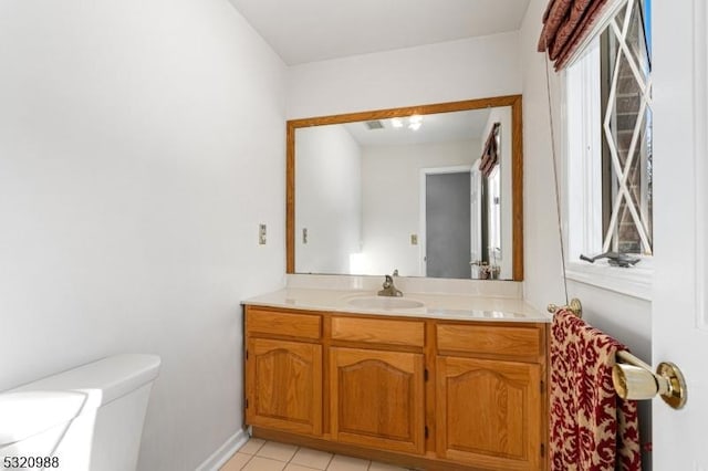 bathroom with vanity, tile patterned floors, and toilet