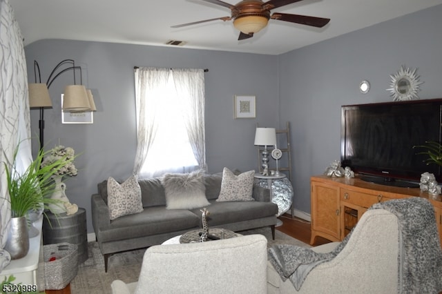 living room featuring wood-type flooring and ceiling fan