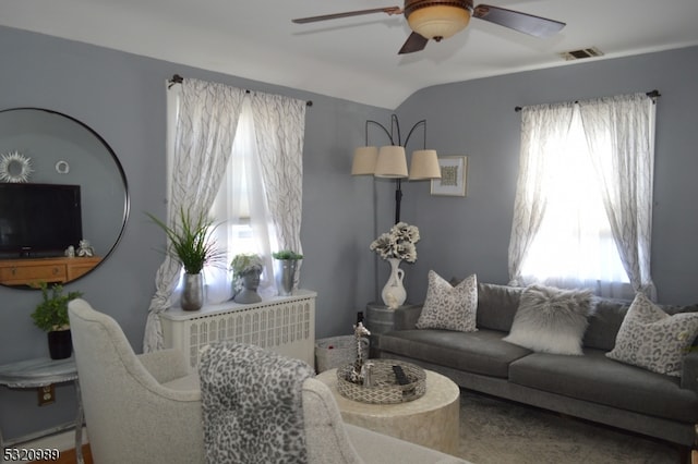 living room with ceiling fan and vaulted ceiling