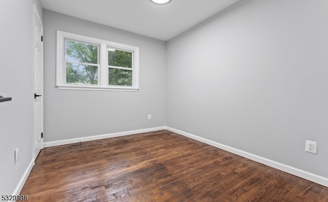 spare room with dark hardwood / wood-style floors