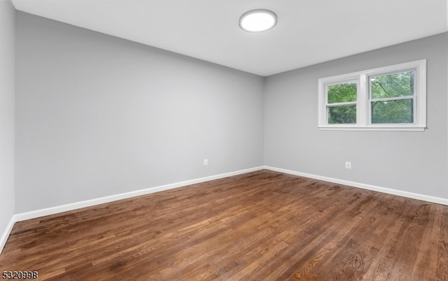 spare room with wood-type flooring