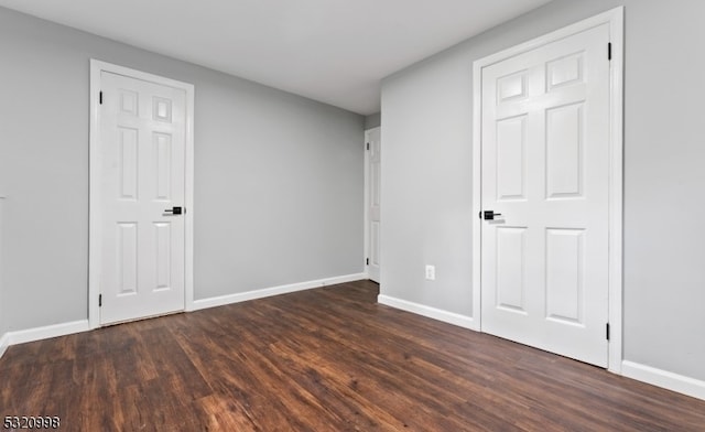 unfurnished bedroom featuring dark hardwood / wood-style flooring