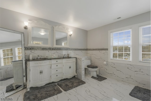 bathroom with tile walls and vanity