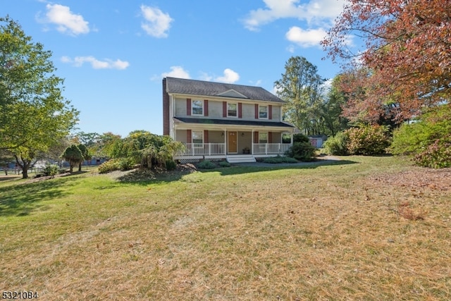 view of front of home with covered porch and a front lawn