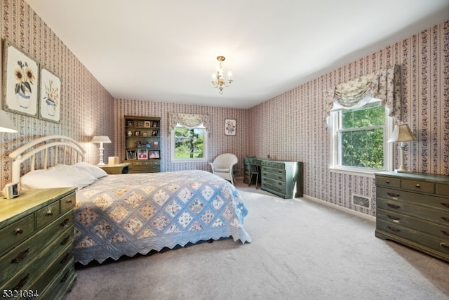 bedroom featuring carpet flooring and a chandelier