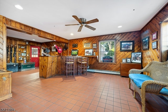 interior space featuring a baseboard heating unit, ceiling fan, an AC wall unit, wooden walls, and tile patterned floors