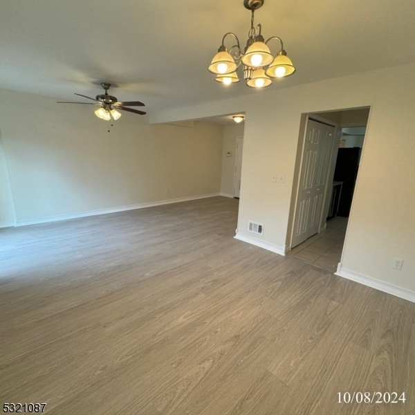 empty room featuring hardwood / wood-style flooring and ceiling fan