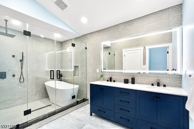 bathroom with vanity, lofted ceiling, and shower with separate bathtub