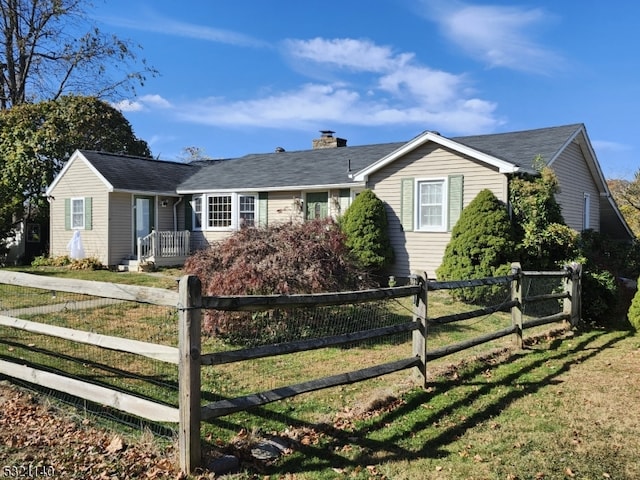 ranch-style home with a front lawn