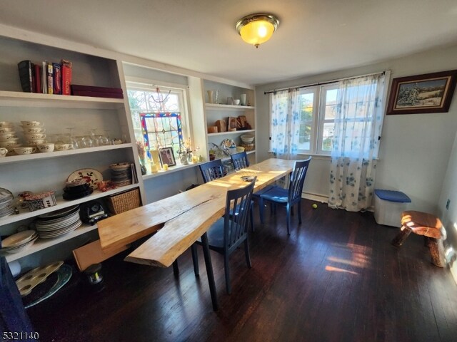 dining room featuring baseboard heating and dark hardwood / wood-style floors