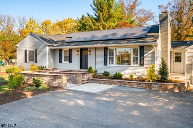 single story home with solar panels