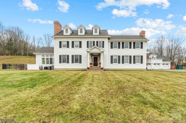 colonial-style house featuring a front lawn