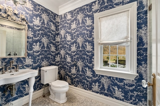 bathroom with tile patterned flooring, a healthy amount of sunlight, toilet, and crown molding