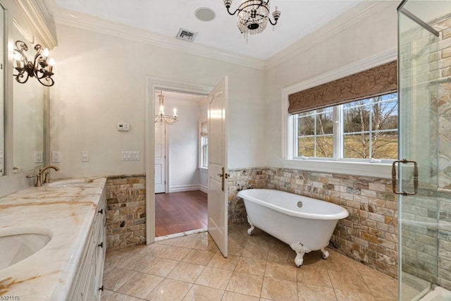 bathroom featuring crown molding, tile patterned flooring, vanity, and a chandelier