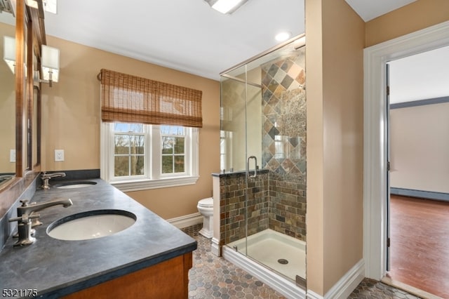 bathroom with walk in shower, tile patterned flooring, vanity, and toilet