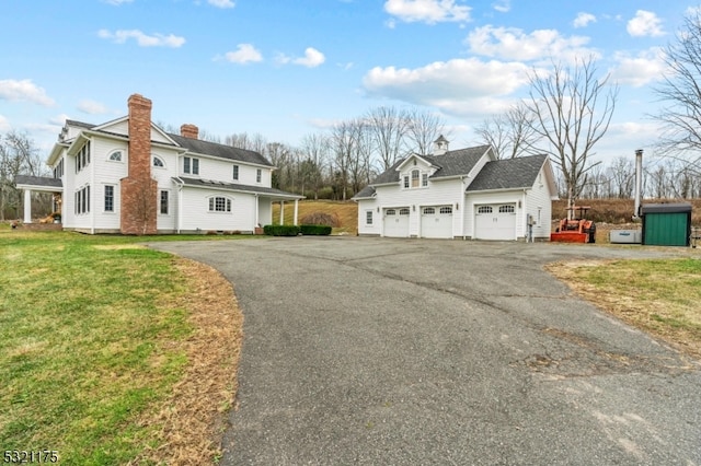 view of front of house featuring a garage and a front lawn