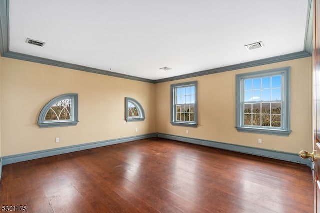 unfurnished room featuring crown molding, dark wood-type flooring, and a baseboard heating unit