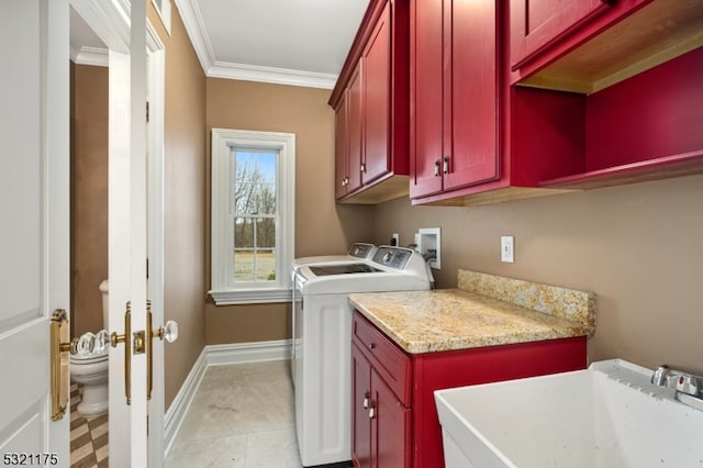 laundry room with washer and clothes dryer, cabinets, sink, ornamental molding, and light tile patterned flooring