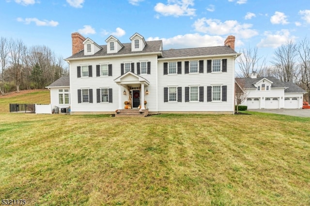 colonial inspired home featuring a front lawn