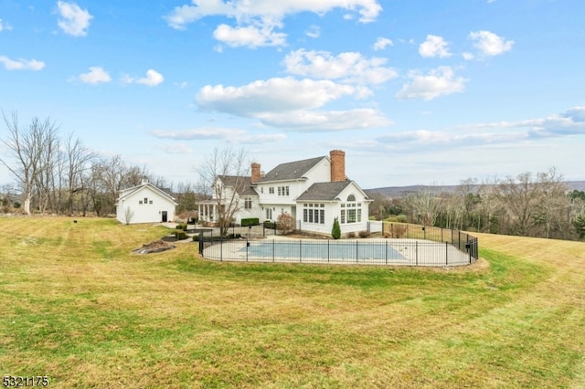 view of pool with a lawn and a patio