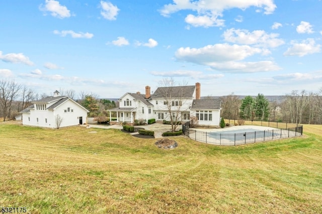 rear view of property with a patio area and a yard