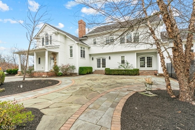 rear view of property with french doors