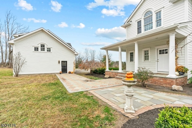 back of house with a yard and a porch