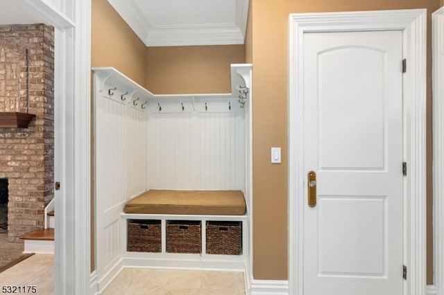 mudroom featuring a fireplace, crown molding, and light tile patterned flooring